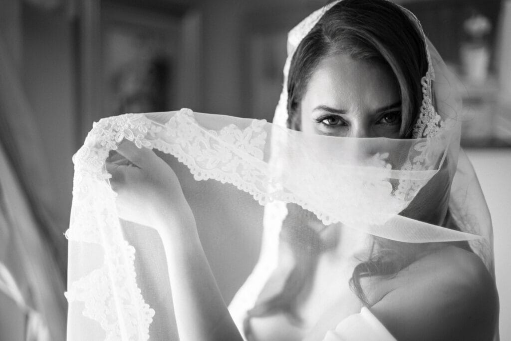 Bride looking through her veil — soft black and white bridal portrait Ottawa