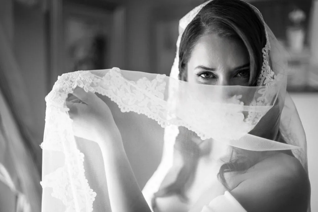 Bride looking through her veil — soft black and white bridal portrait Ottawa