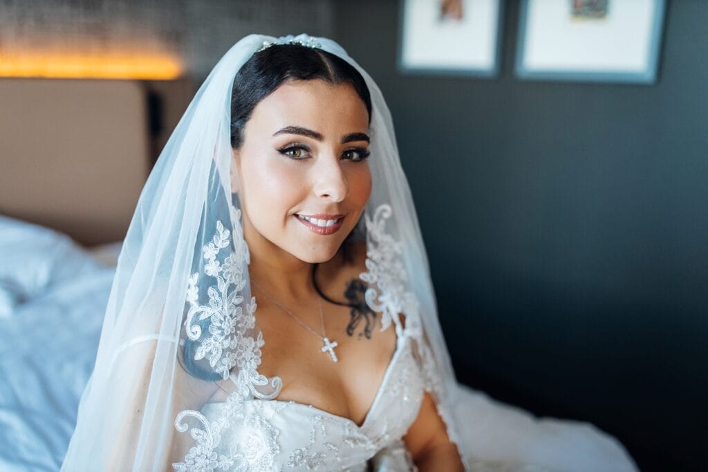 Bride smiling softly in lace veil before ceremony — St. Mark and St. Mary of Egypt Church Ottawa wedding
