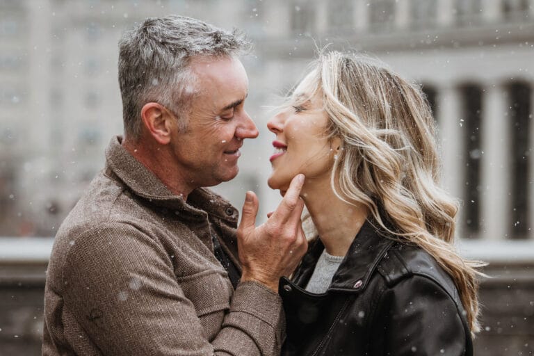 Romantic winter engagement portrait of a couple during a snowy day in Ottawa